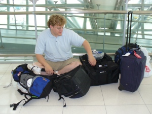 Sean amidst a pile of luggage in Bangkok.  What's that he's opening?